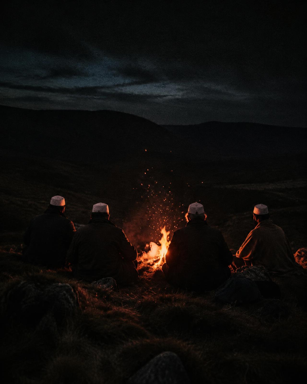 Brothers around a campfire at night